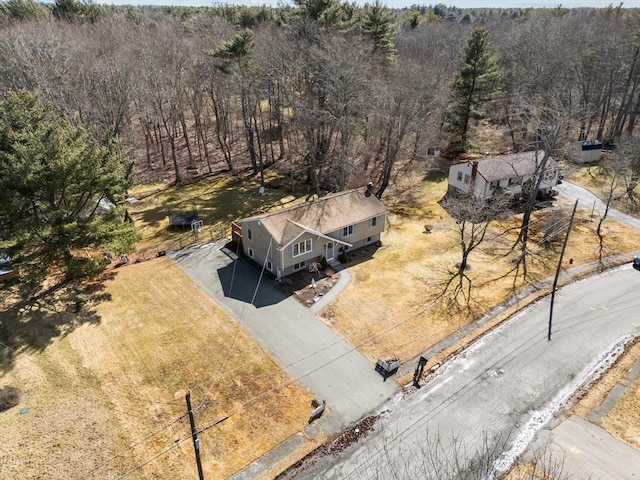 bird's eye view with a wooded view