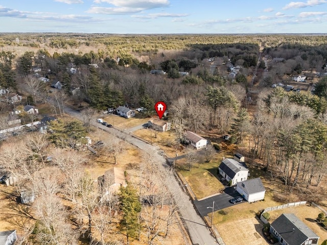 bird's eye view with a wooded view