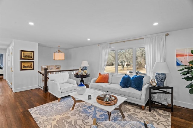 living room featuring recessed lighting, baseboards, and wood finished floors