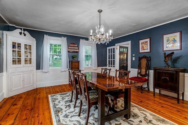 dining room featuring ornamental molding and hardwood / wood-style flooring