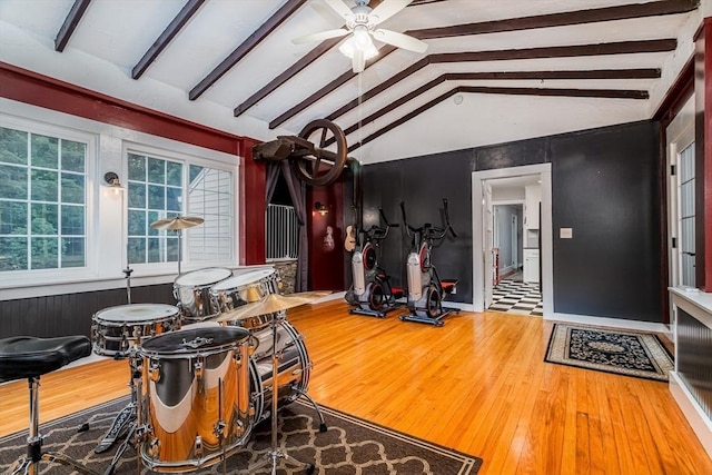 dining space featuring ceiling fan, lofted ceiling with beams, and wood finished floors