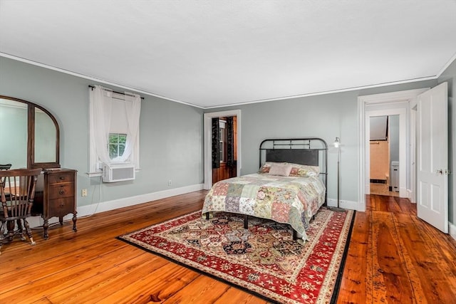 bedroom with ornamental molding, cooling unit, wood finished floors, and baseboards