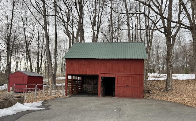 view of outbuilding featuring an outbuilding and fence