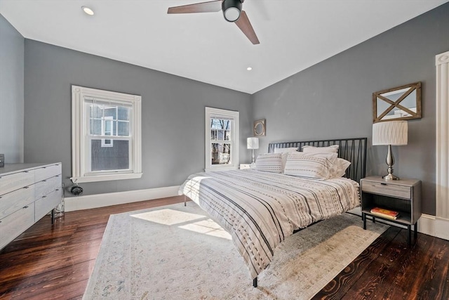 bedroom with recessed lighting, vaulted ceiling, baseboards, and wood finished floors