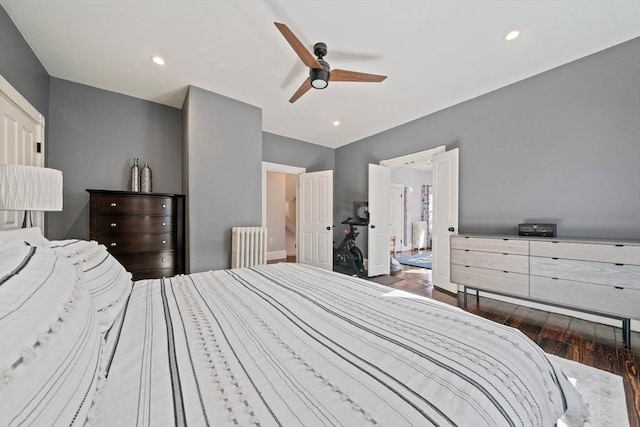 bedroom with a ceiling fan, recessed lighting, radiator, and wood finished floors