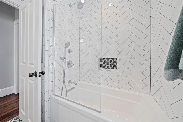 bathroom featuring bathing tub / shower combination and wood finished floors