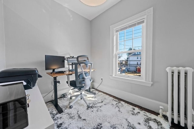 home office featuring radiator and baseboards