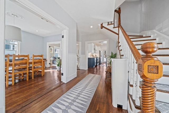 entryway featuring stairway, wood finished floors, and a healthy amount of sunlight