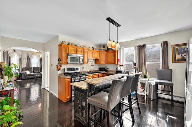 166 Beattie St Unit 2, Fall River, MA 02723 - kitchen with stainless steel appliances, a sink, plenty of natural light, and arched walkways