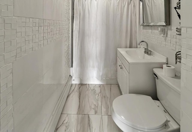 166 Beattie St Unit 2, Fall River, MA 02723 - full bathroom with tile walls, marble look tile flooring, toilet, shower / tub combo, and vanity