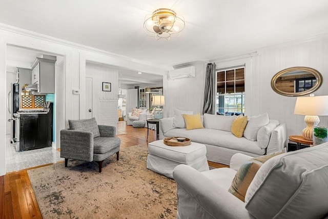 living room featuring an AC wall unit, crown molding, and wood finished floors