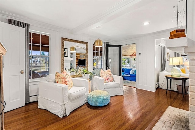 living area featuring baseboard heating, ornamental molding, beam ceiling, and hardwood / wood-style flooring