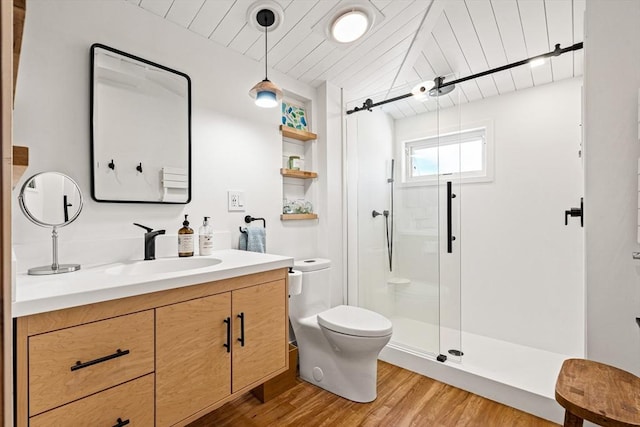 full bathroom with vanity, a stall shower, wood finished floors, and toilet