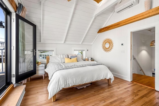 bedroom with an AC wall unit, lofted ceiling with beams, wooden ceiling, and light wood-style flooring