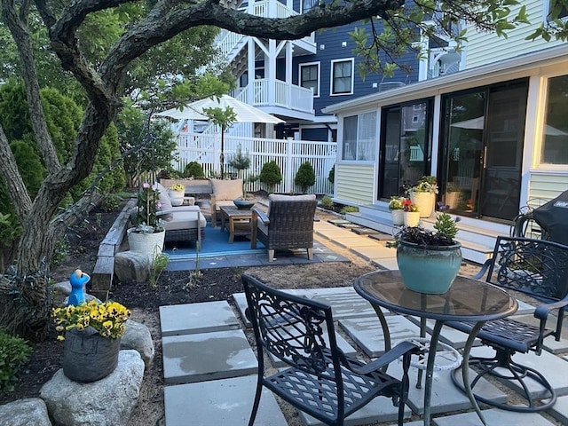 view of patio / terrace with outdoor dining area, fence, and an outdoor hangout area
