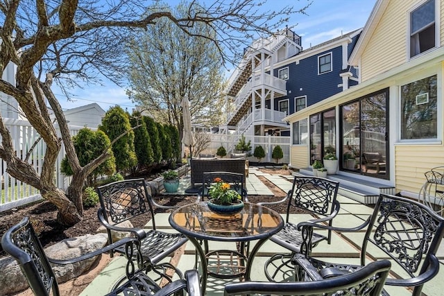 view of patio with fence and outdoor dining area