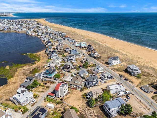 aerial view featuring a water view, a view of the beach, and a residential view