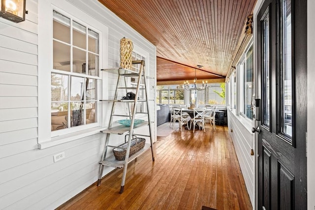 sunroom featuring a chandelier