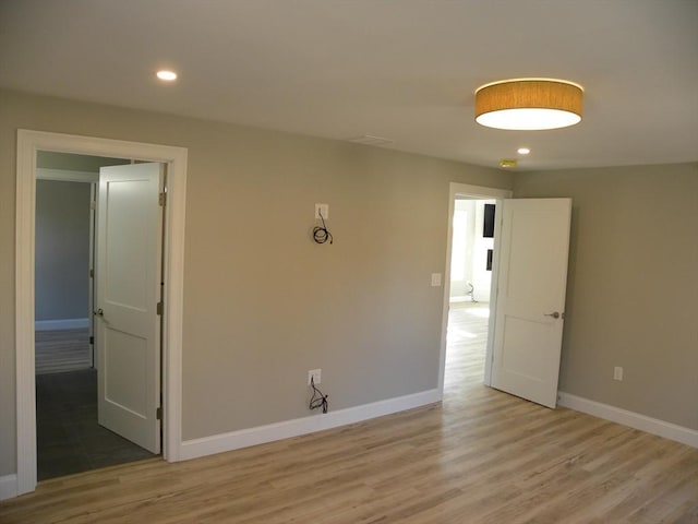 unfurnished room with recessed lighting, baseboards, and light wood-style flooring