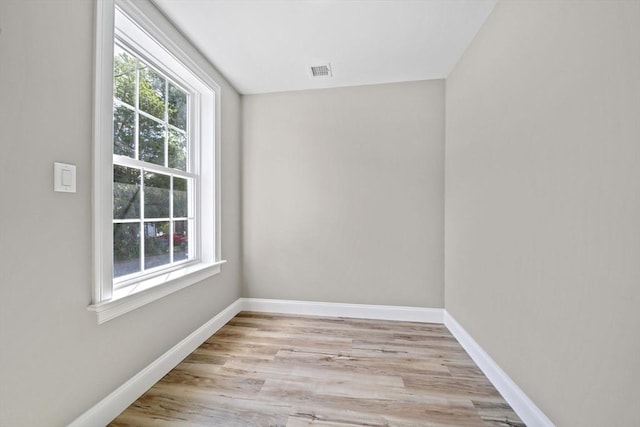 unfurnished room with visible vents, baseboards, and light wood-type flooring