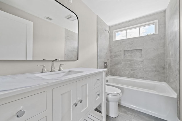 bathroom featuring vanity, toilet, visible vents, and shower / washtub combination