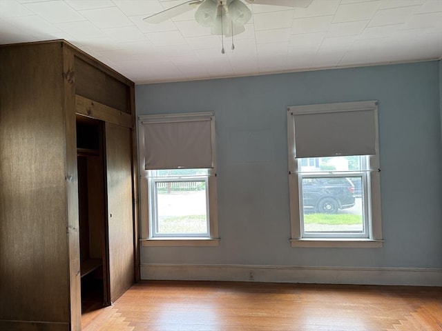 unfurnished bedroom featuring multiple windows and light wood-type flooring