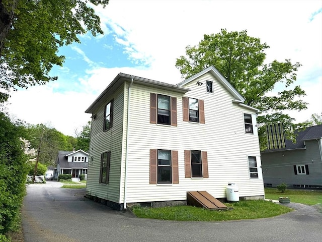 view of side of home featuring driveway