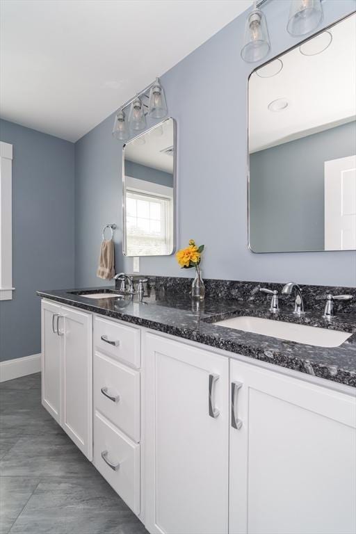 32 Charles St, Natick, MA 01760 - bathroom featuring double vanity and baseboards