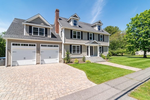 32 Charles St, Natick, MA 01760 - view of front of property with decorative driveway, a front lawn, a chimney, and roof with shingles