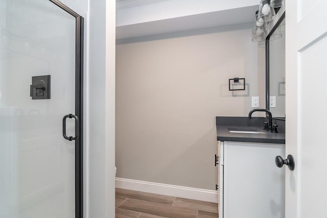 32 Charles St, Natick, MA 01760 - bathroom featuring vanity, baseboards, a shower stall, wood finished floors, and toilet
