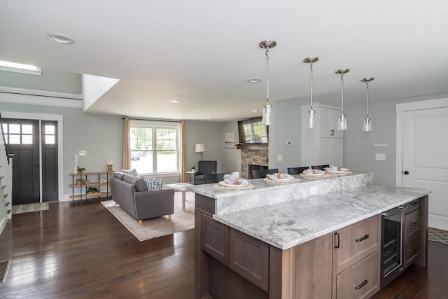 32 Charles St, Natick, MA 01760 - kitchen featuring wine cooler, open floor plan, dark wood-style floors, a kitchen island, and recessed lighting