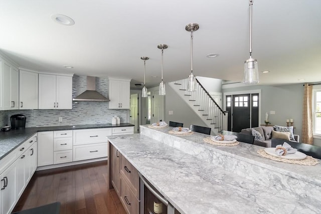 32 Charles St, Natick, MA 01760 - kitchen featuring wall chimney exhaust hood, tasteful backsplash, dark wood-type flooring, hanging light fixtures, and recessed lighting