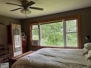 bedroom featuring cooling unit and ceiling fan