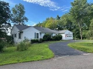 view of front of home with a garage and a front lawn