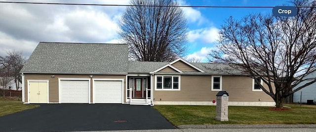 view of front of house with a front yard and a garage