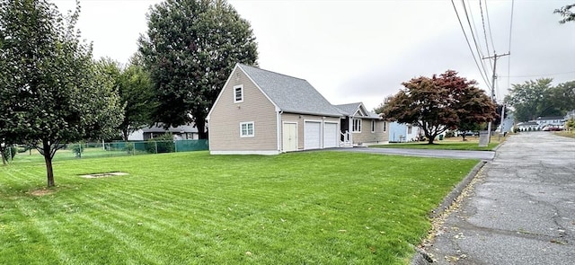 view of home's exterior featuring a garage and a yard