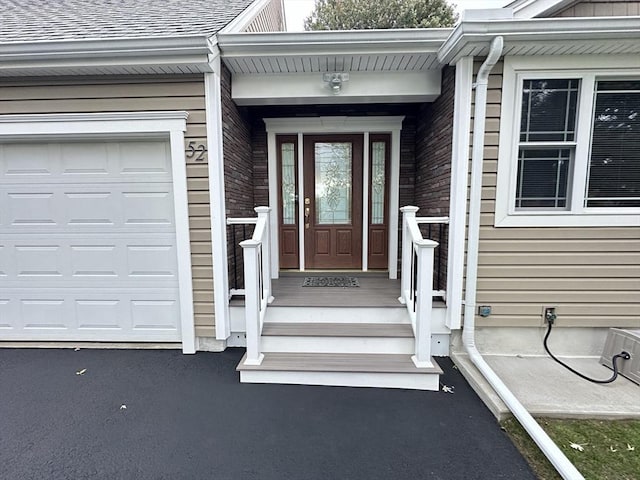 view of exterior entry with a garage