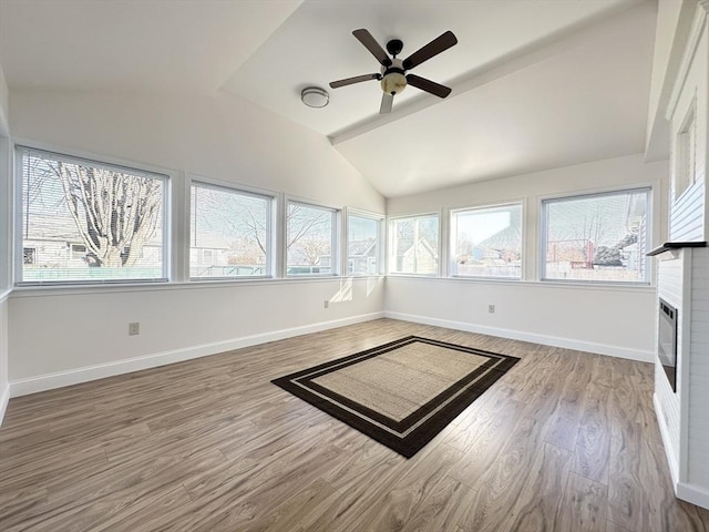 unfurnished sunroom with ceiling fan and lofted ceiling