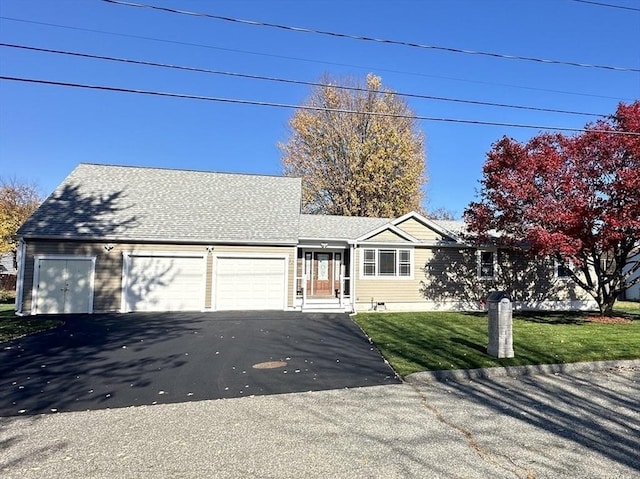 view of front of property featuring a garage and a front lawn