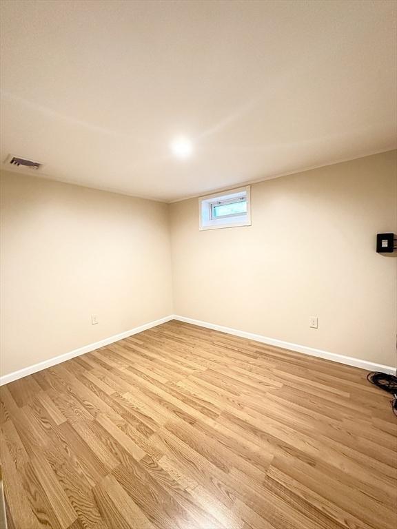 basement with light hardwood / wood-style floors