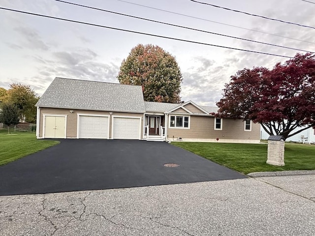 view of front of home with a front yard and a garage