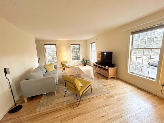 living room featuring baseboards and light wood-type flooring