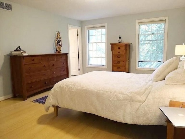 bedroom featuring visible vents and light wood-style flooring