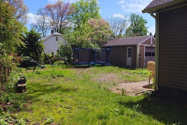 27 Bushwick Pl, Springfield, MA 01109 - view of grassy yard with an outdoor structure and a trampoline