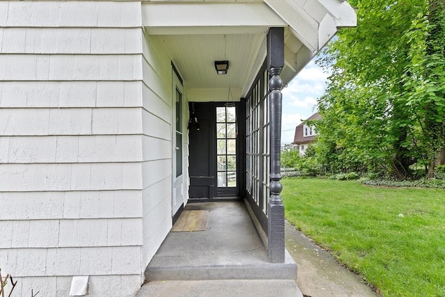 property entrance with a yard