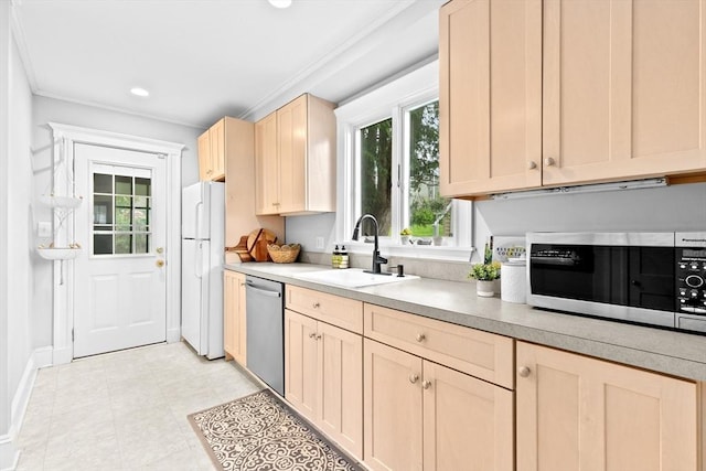 kitchen with stainless steel appliances, a sink, light brown cabinets, light countertops, and ornamental molding