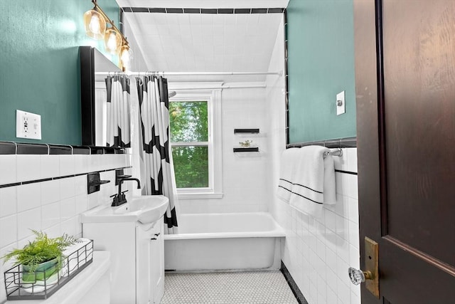 bathroom with tile walls, vanity, tile patterned floors, and toilet