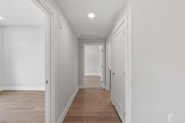 hall with recessed lighting, visible vents, baseboards, and light wood-type flooring
