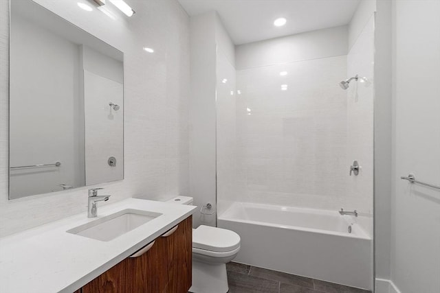bathroom with toilet, vanity, and shower / tub combination