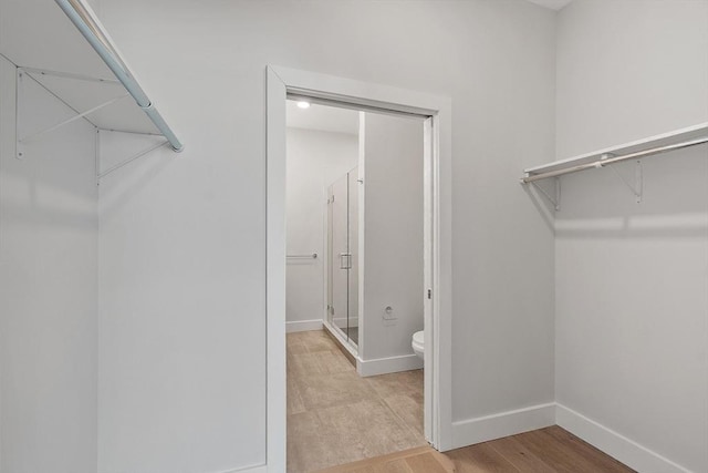 spacious closet featuring light wood finished floors